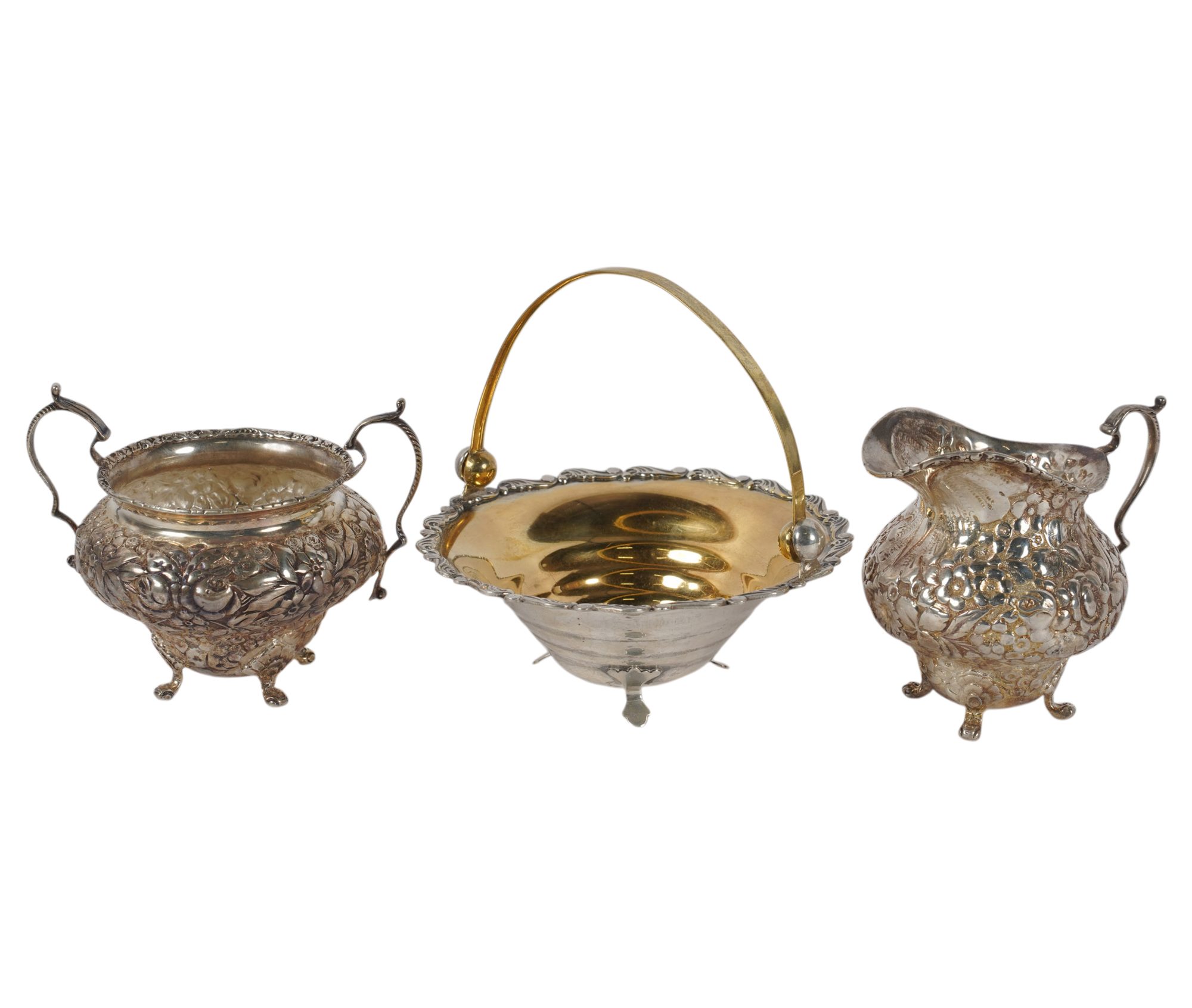 An Embossed Sterling Creamer, Sugar, and Candy Dish